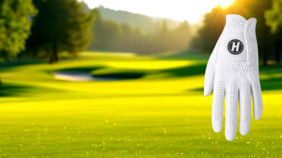 Premium white cabretta golf glove on green golf course background